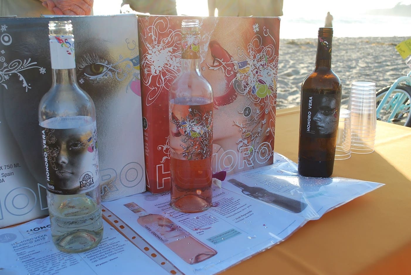 A table with some bottles and papers on it