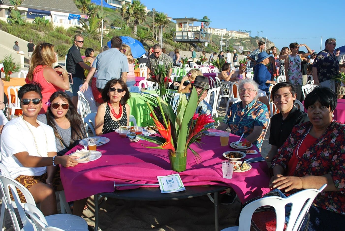 A group of people sitting at a table with food.